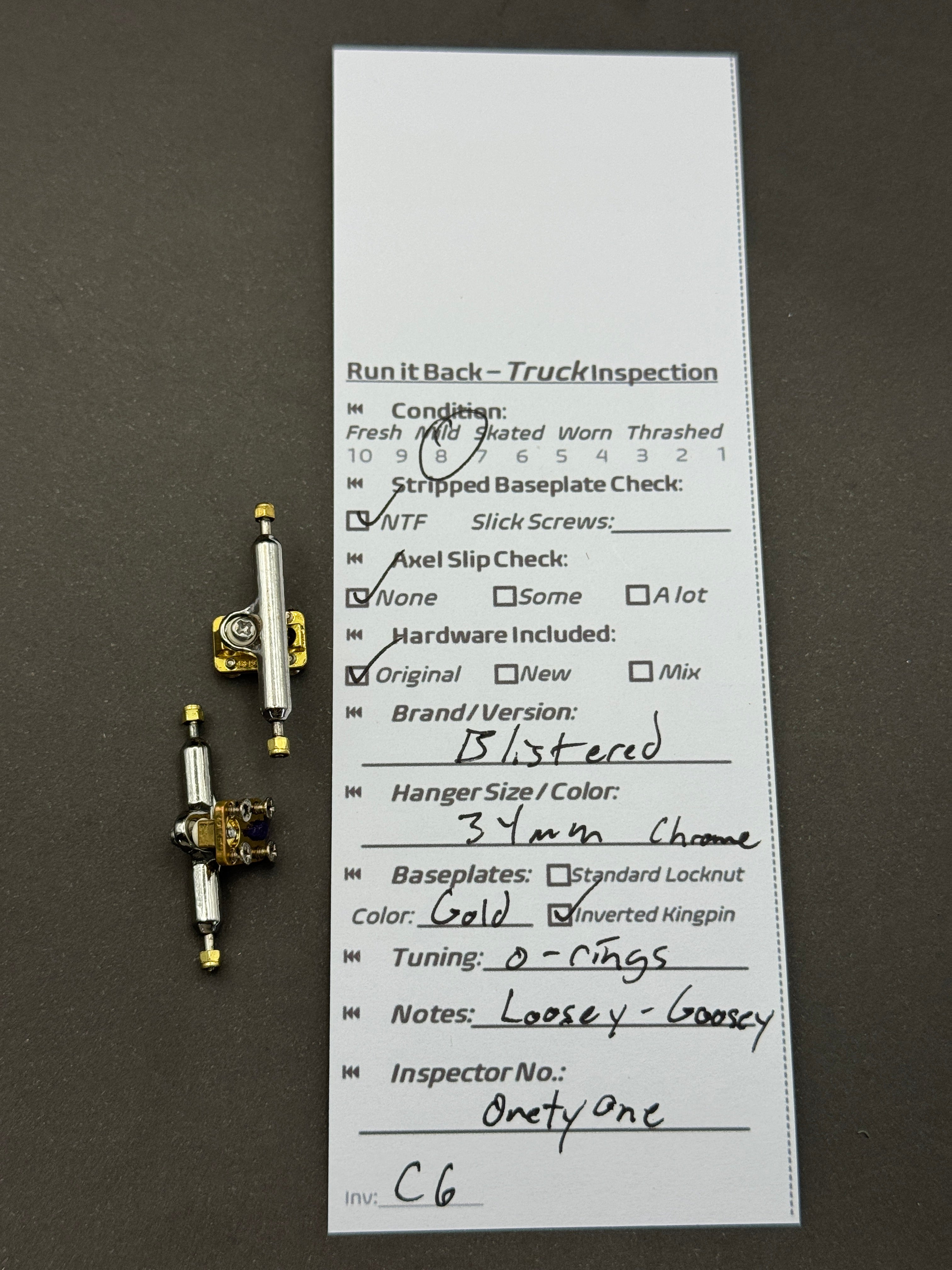 Blistered 34mm Chrome / Gold trucks – inspection card