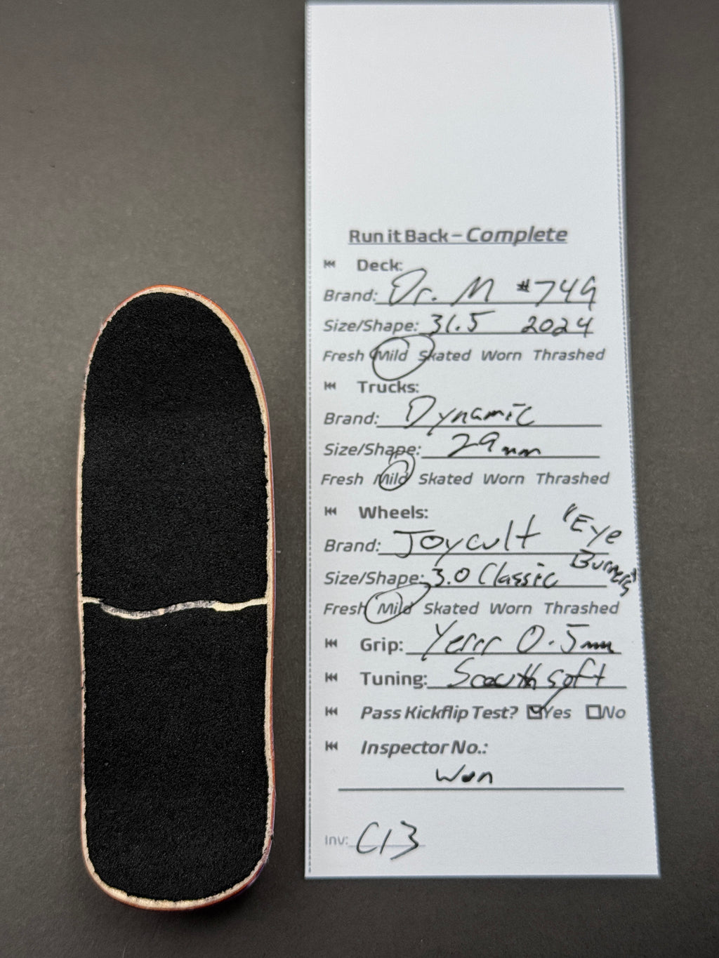 DR. M #744 complete fingerboard with Dynamic trucks and orange Joycult Eye Burners wheels