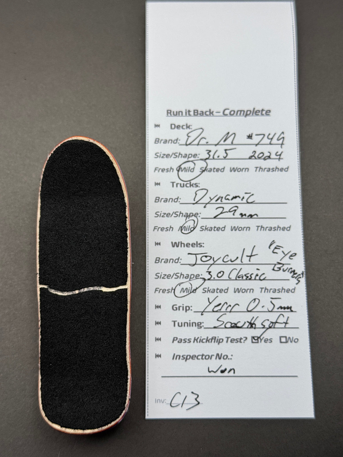 DR. M #744 complete fingerboard with Dynamic trucks and orange Joycult Eye Burners wheels